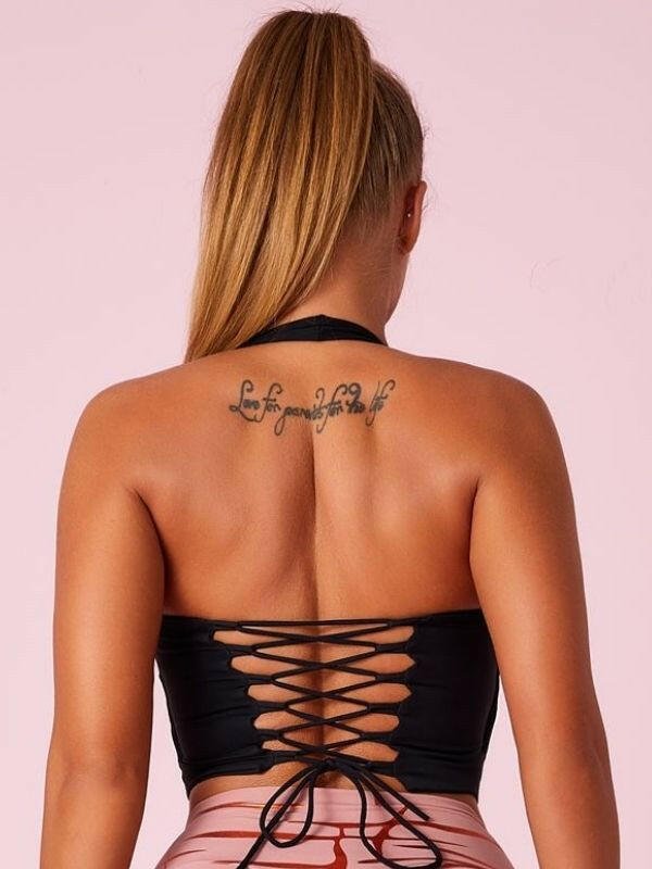 Black Lumina Vancouver sports bra with Roman knot halter design and beautify back, perfect for active wear.