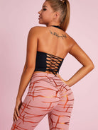Black Lumina Vancouver sports bra with Roman knot halter design and beautify back detail, ideal for active wear and workout support.