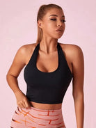 Black Lumina Vancouver sports bra with Roman knot halter design and beautify back detail, designed for active wear and support.