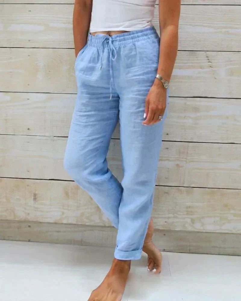 Light beige linen trousers for women by Lumina Wear featuring a modern fit, lightweight fabric, and slim leg design.