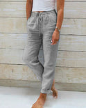 Lightweight beige linen pants for women by Lumina Wear, modern fit, featuring a relaxed style and casual elegance.