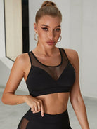 Black mesh sports bra from Lumina Vancouver, featuring a unique, sexy design, paired with matching leggings in a stylish athletic set.