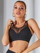 Black mesh sports bra by Lumina Vancouver, featuring a sleek design with a bonus matching jacket for activewear style.
