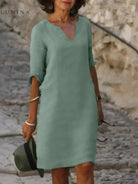 Black Suzan elegant dress with V-neckline by Lumina Vancouver, displayed on a mannequin showing the fitted design.