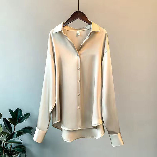 Beige Taylor Lumina relaxed fit blouse with button detail, displayed on a hanger showing its elegant, casual style.