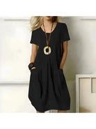 Green Tia dress by Lumina Vancouver, stylish one-color dress with flattering tummy coverage and elegant fit.