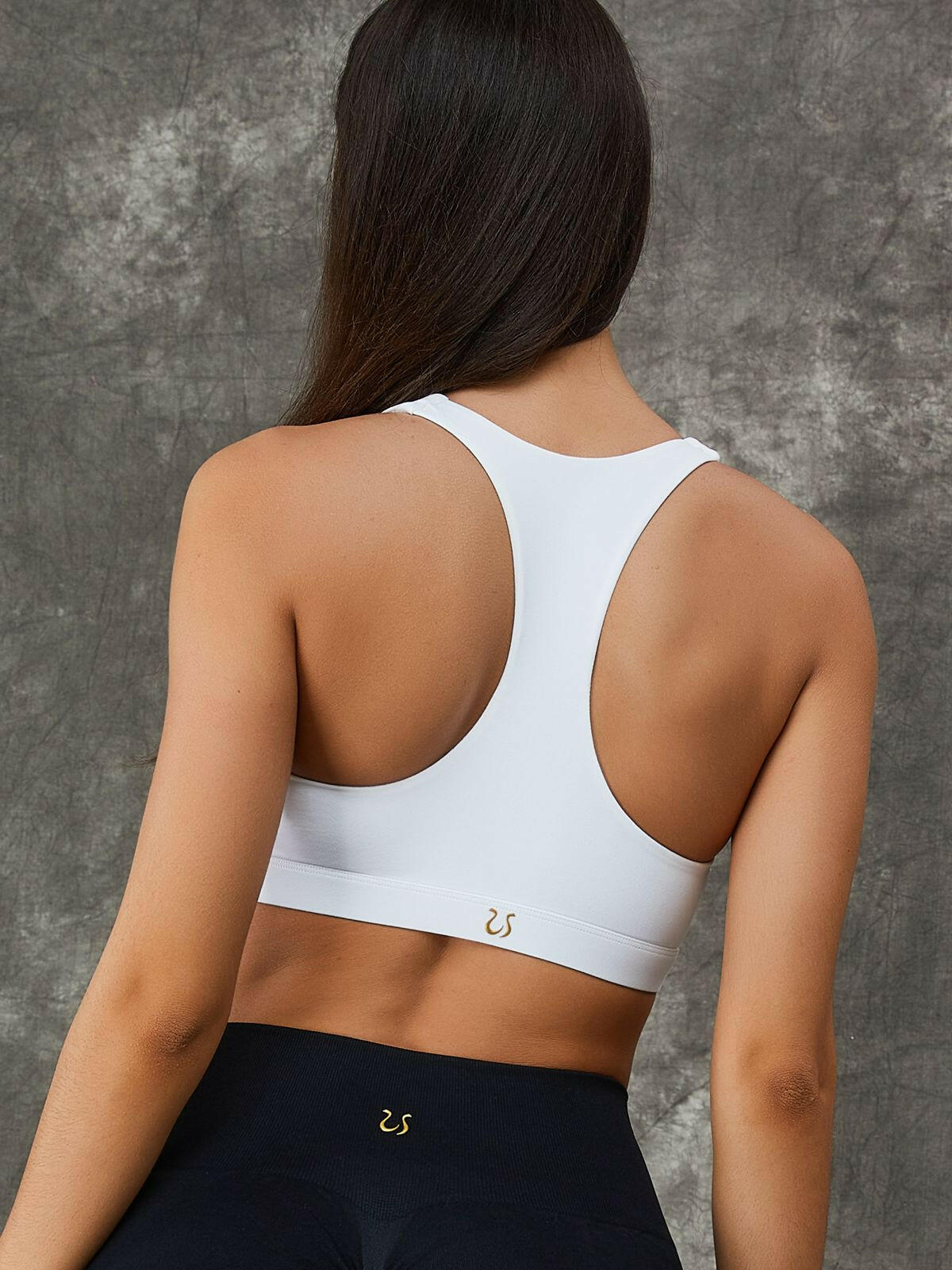 White Twist Hollow Out Sports Bra by Lumina Vancouver with fishnet cutout design, featuring a stylish and breathable sports bra look.