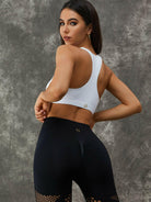 White Lumina Vancouver Twist Hollow Out Sports Bra with fishnet cutout design, featuring a stylish twist detail and breathable fabric.