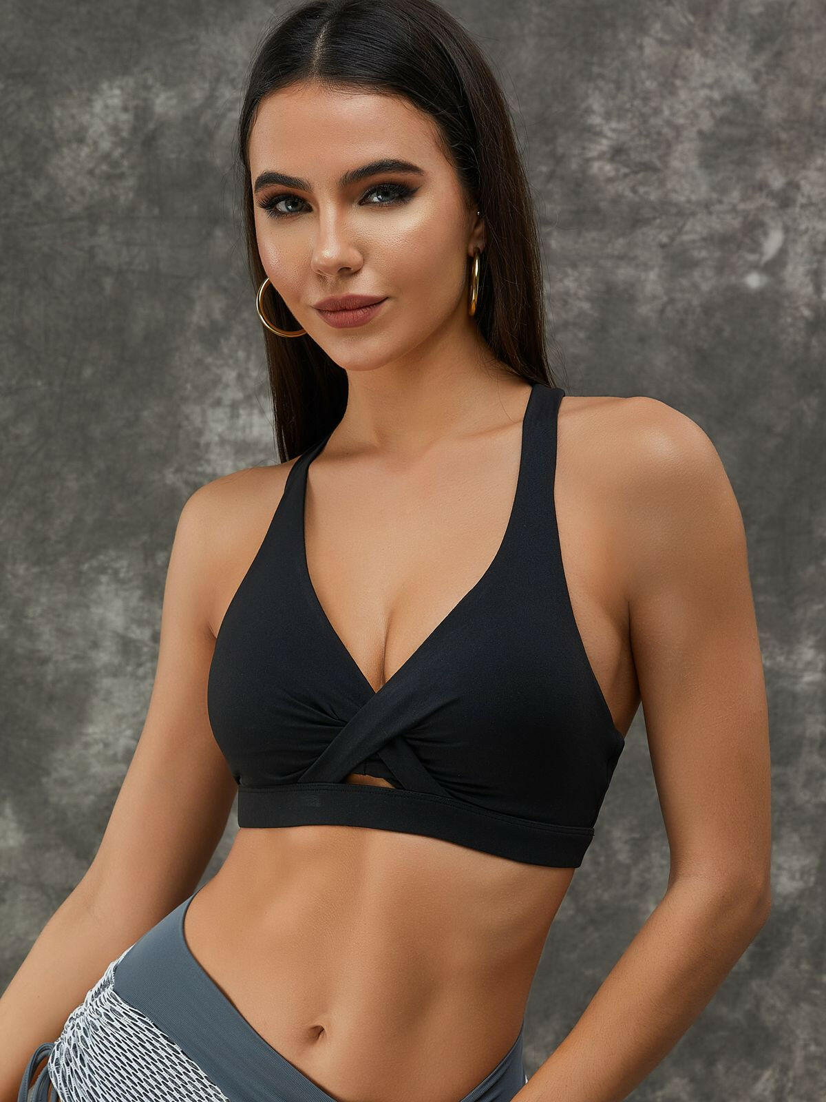 White Lumina Vancouver sports bra with twist hollow out design and fishnet cutouts, featuring a stylish and breathable fit.