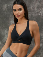 White Lumina Vancouver sports bra with twist hollow out design and fishnet cutouts, featuring a stylish and breathable fit.
