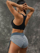 White Lumina Vancouver twist hollow out sports bra with fishnet cutouts, featuring a stylish and breathable design for active wear.