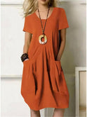 Orange Lumina Wear Ubud casual dress with short sleeves and relaxed fit, displayed on a hanger.