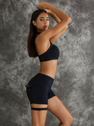 Black Lumina Vancouver sports bra with unique cut-out design, breathable fabric, and supportive fit for active wear.