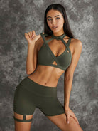Dark sea green Lumina Vancouver sports bras with unique cut-out design, shown as a bundle in this image.