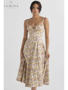 White Venura spring wedding guest dress by Lumina Vancouver with floral print, perfect for spring and summer occasions.