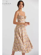 White Venura spring wedding guest dress by Lumina Vancouver featuring a floral print, perfect for spring and summer occasions.