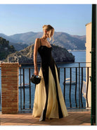 Black and white Viara paneled maxi dress by Lumina Vancouver, flowing fabric with stylish panel details, full-length dress on model.