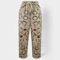 Light beige Lumina Wear relaxed trousers with elastic waistband and circle print, casual and comfortable for everyday wear.
