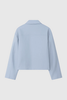 Light blue Victoria Lumina bomber jacket with zipper closure, casual style, shown on a person with pockets and ribbed cuffs.