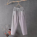 Victoria Lumina Wear casual white trousers with elastic waistband, featuring a relaxed fit and lightweight fabric.