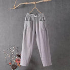 Victoria Lumina white casual trousers with elastic waistband, featuring a relaxed fit and comfortable fabric, shown on a model.