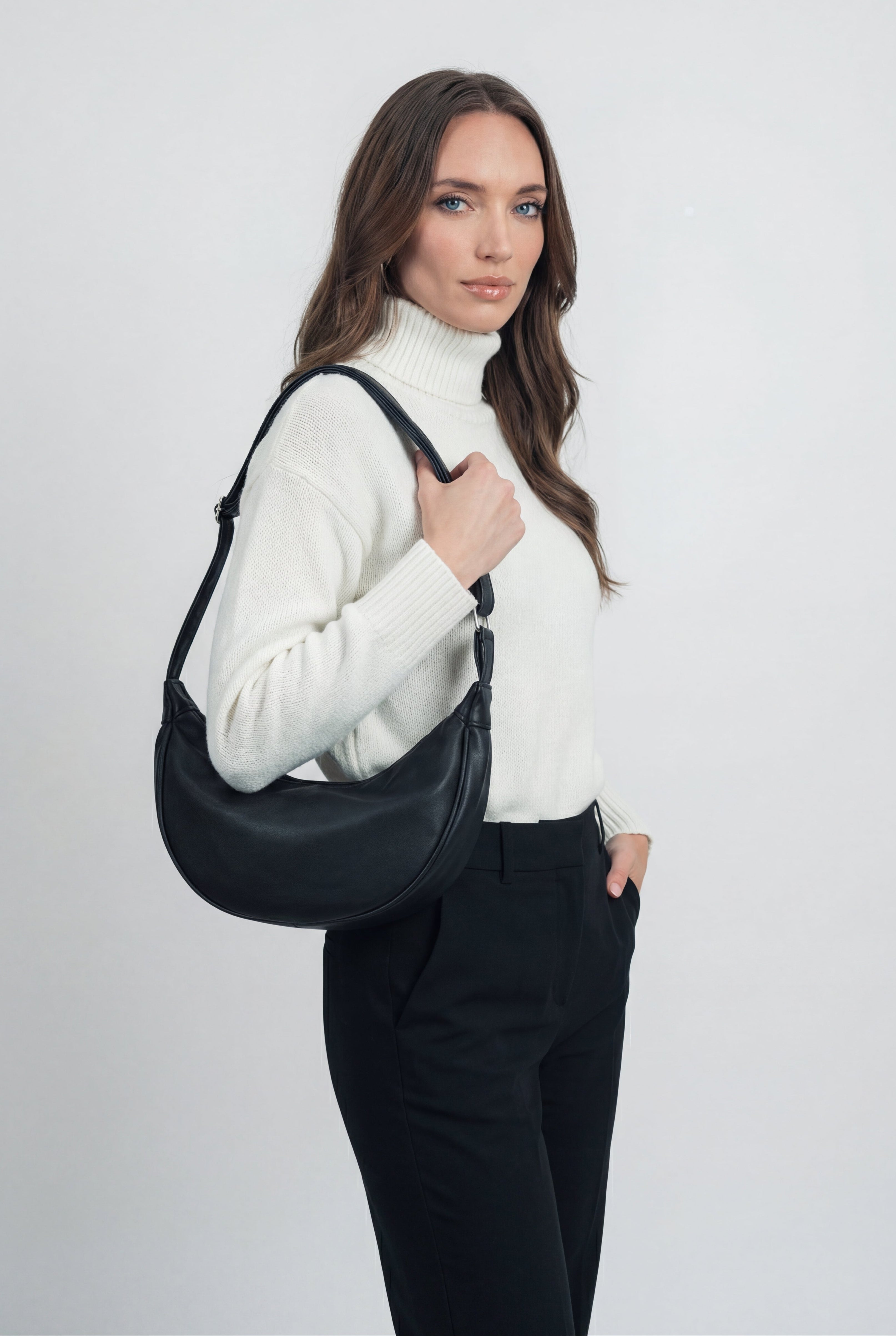 Black Lumina Wear Victoria handbag with adjustable belt and multiple pockets, stylish and functional for everyday use.