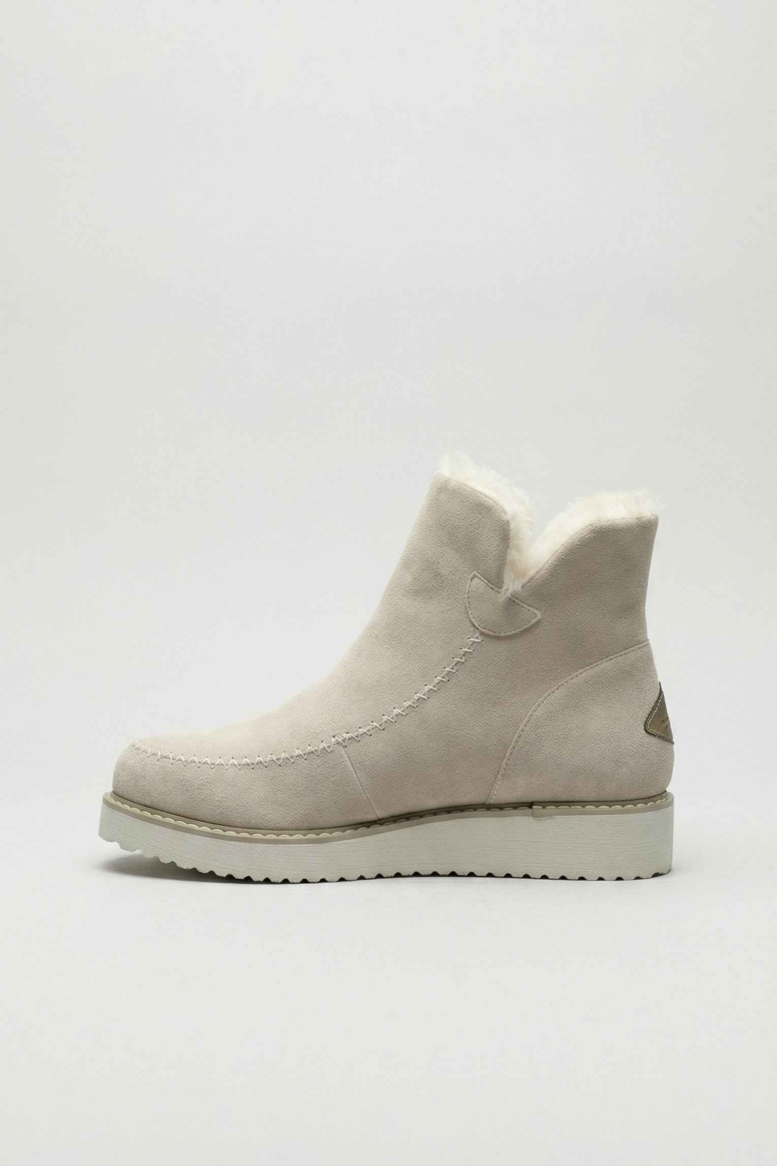 Chic beige ankle boots by Lumina Wear with durable sole, stylish design, and ankle height on a plain background.