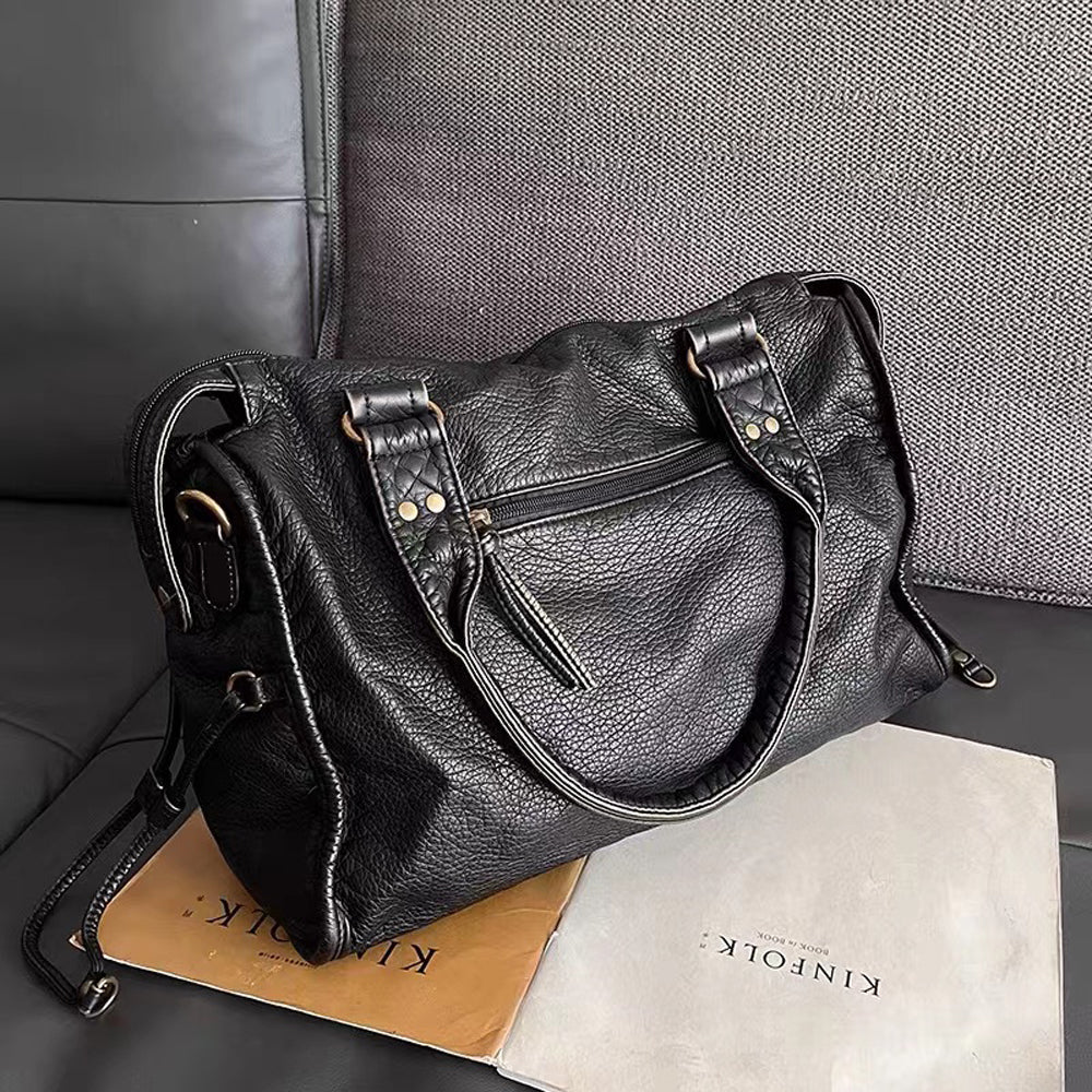 Victoria Lumina black PU leather handbag with multiple pockets, stylish design, and sleek handles for versatile everyday use.