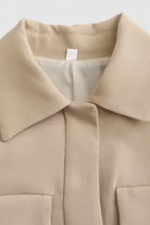 Khaki Victoria Lumina Wear chic cropped button jacket with a flattering fit, styled with long sleeves and front buttons.