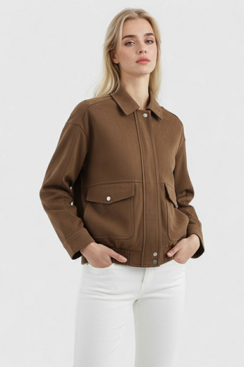 Victoria dark brown suede bomber jacket with zipper closure by Lumina Wear, displayed on a hanger.