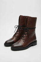Lumina Wear Victoria cozy brown lace-up ankle boots with chic detailing, featuring stylish design and dark brown leather finish.