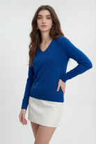Dark blue Victoria Lumina Wear V-neck sweater with a cozy fit, perfect for casual or office wear, shown on a model.