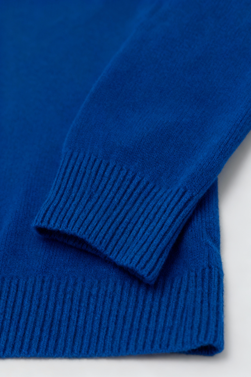 Dark blue Victoria Lumina Wear V-neck sweater with a cozy fit, featuring a flattering silhouette and soft knit texture.
