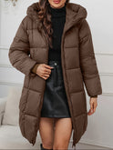 Redish-brown Victoria Lumina Wear longline hooded puffer coat with practical pockets, cozy and insulated for cold weather.