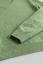 Victoria Lumina cozy olive green sweater with flattering V-neck, soft knit, and comfortable fit.