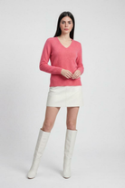 Victoria Lumina Wear cozy pink-red v-neck sweater with flattering fit, displayed on a neutral background.