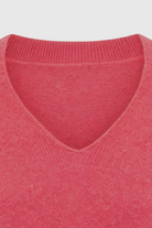 Pink and red V-neck sweater from Lumina Wear, cozy fit, with a flattering silhouette, perfect for casual or stylish wear.