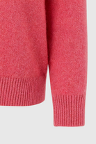 Victoria Lumina pink and red V-neck sweater with a cozy, flattering fit, perfect for casual wear, displayed on a hanger.