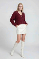 Victoria Cozy Red Long Cardigan by Lumina Wear with ribbed details, shown draped on a model in a casual setting.
