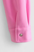 Elegant apricot women's jacket by Lumina Wear featuring classic button closure and tailored fit, perfect for stylish layering.
