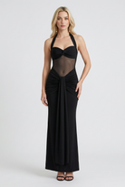 Elegant black halter dress with sculpted silhouette by Lumina Wear, modeled on a woman showcasing the stylish fit and design.