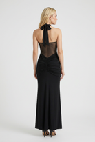 Elegant black halter dress by Lumina Wear featuring a sculpted silhouette, showcased on a model. Perfect for formal occasions.
