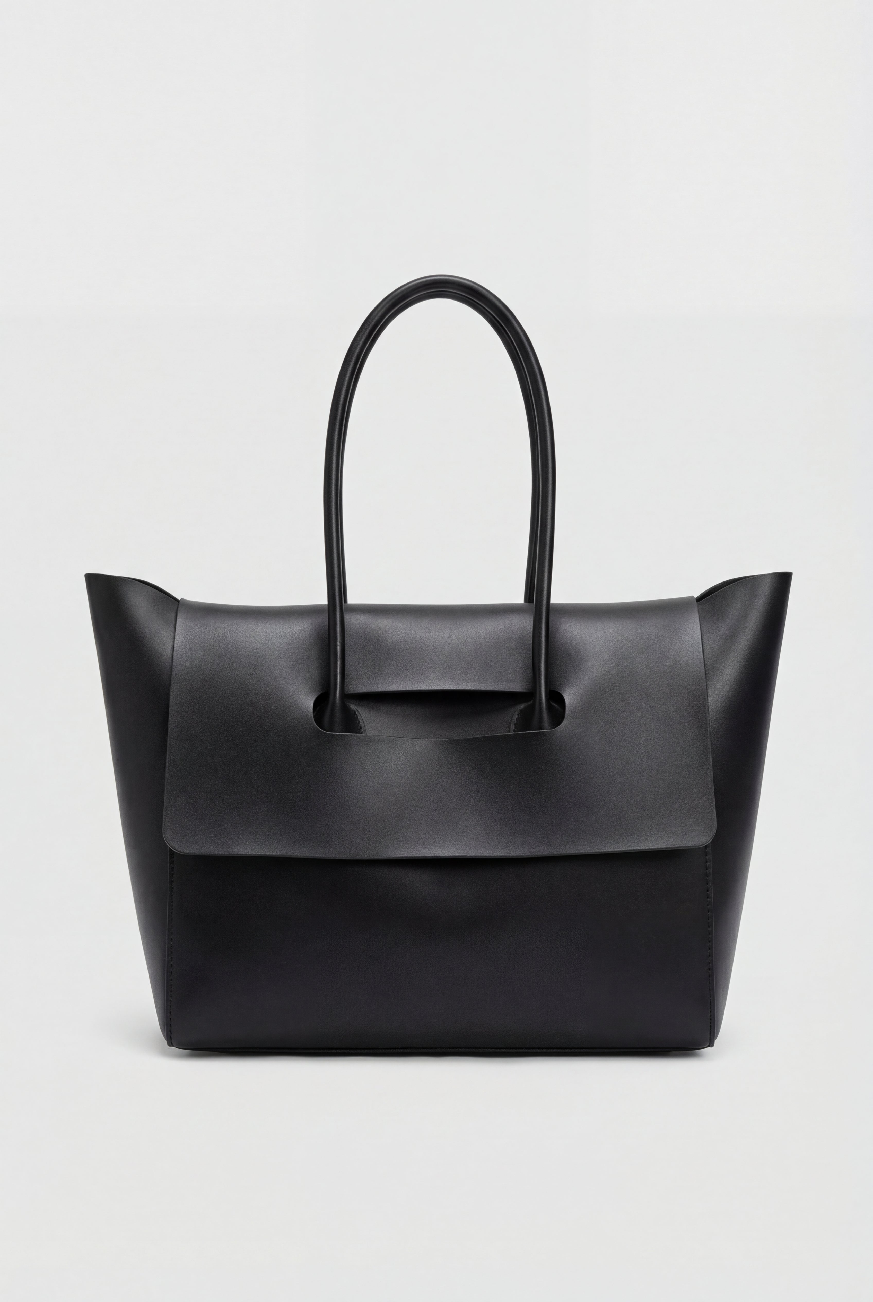 Elegant black Lumina Wear handbag with an adjustable strap, featuring a sleek design and structured silhouette.