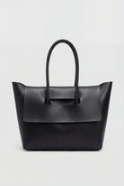 Elegant black Lumina Wear handbag with an adjustable strap, featuring a sleek design and structured silhouette.