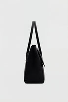 Elegant black Lumina Wear Victoria handbag with adjustable strap, featuring a sleek design and structured shape.