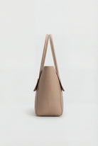Elegant black Lumina Wear handbag with adjustable strap, featuring a sleek design and stylish handles for versatile use.