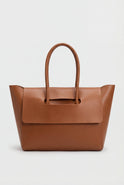 Elegant black Lumina Wear handbag with adjustable strap, featuring a sleek design and structured shape.