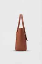 Elegant black Lumina Wear handbag with adjustable strap, featuring a sleek design and stylish handles for versatile use.