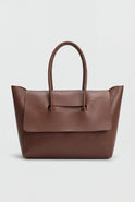 Elegant black Lumina Wear Victoria handbag with adjustable strap, featuring sleek design and top handle for versatile style.
