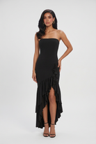 Elegant black maxi dress with asymmetrical ruffle by Lumina Wear, featuring a flowing silhouette and stylish design.